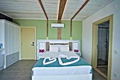 a bedroom with a bed with two towels at Stonehillkaş in Kas