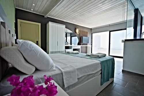 a bedroom with a bed with purple flowers on the floor at Stonehillkaş in Kas