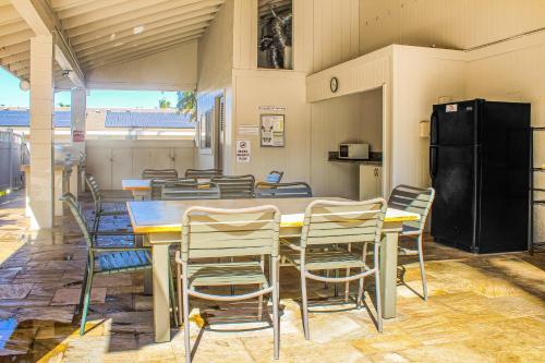 a dining room with a table and chairs at Kihei Akahi in Wailea