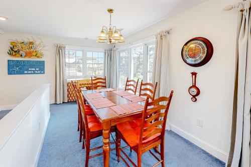 a dining room with a wooden table and chairs at Island TIme Avon 910 in Avon