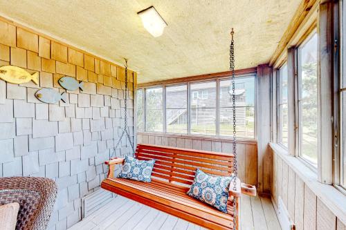 a porch swing in a room with a window at Island TIme Avon 910 in Avon