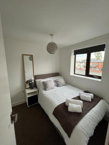 a bedroom with a bed with two pillows on it at Spacious 1 Bedroom Apartment with free parking in Wednesbury