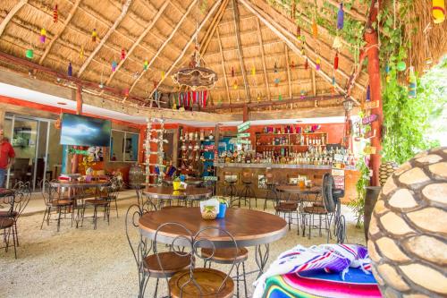ein Restaurant mit Tischen und Stühlen und eine Bar in der Unterkunft Hotel Tequila Cancun in Cancún