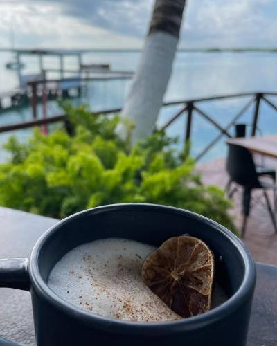 a cup of coffee with a leaf in it at Hotel Aldea 19 Bacalar in Bacalar