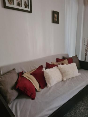 a gray couch with many pillows on it at AP CENTRO in San Juan