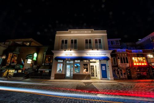 a building on a city street at night at The Newport Lofts - 194 Thames Street in Newport