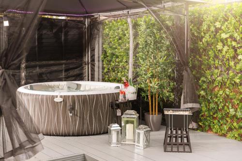 a bath tub in a tent with plants at Home From Home Northampton in Northampton