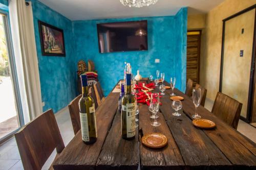 a wooden table with three bottles of wine on it at Hotel Tequila Cancun in Cancún