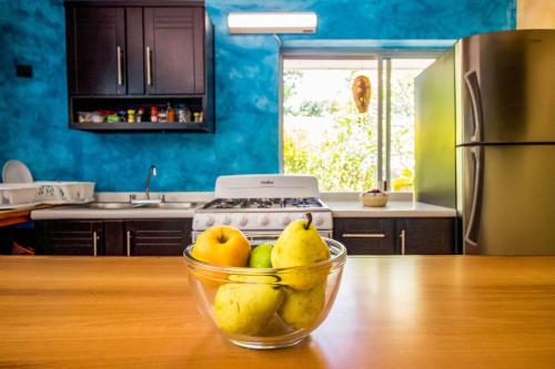 a bowl of fruit on a table in a kitchen at Hotel Tequila Cancun in Cancún