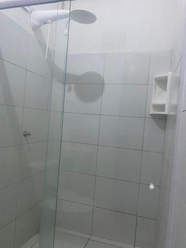 a shower with a glass door in a bathroom at Pousada Paracuru Surf in Paracuru