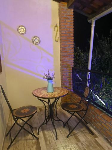 a small table and two chairs on a patio at Pousada Paracuru Surf in Paracuru