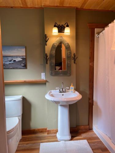 a bathroom with a sink and a mirror at Frigon Suite -Waterfront in Port Alice