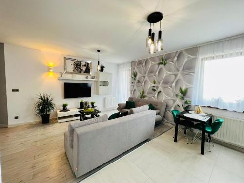 a living room with a couch and a tv at Apartament Eva 2 in Jelenia Góra