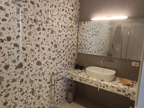 a bathroom with a sink and a mirror at Live Home Rooms in Villasimius