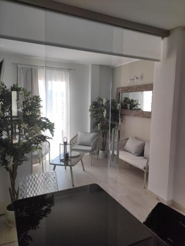 a living room with a large glass wall at Live Home Rooms in Villasimius