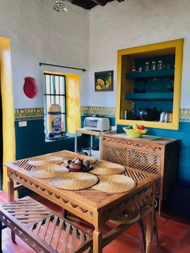 a kitchen with a wooden table in a room at FINCA COCUYAL Hospedaje típico paisa in Rionegro