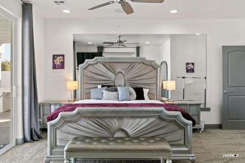 a bedroom with a large bed and a mirror at Greek Goddess, Private Heated Pool and Hot Tub in Hurricane