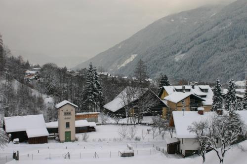 a village covered in snow with mountains in the background at Haus Alpenblick Mölltal in Flattach