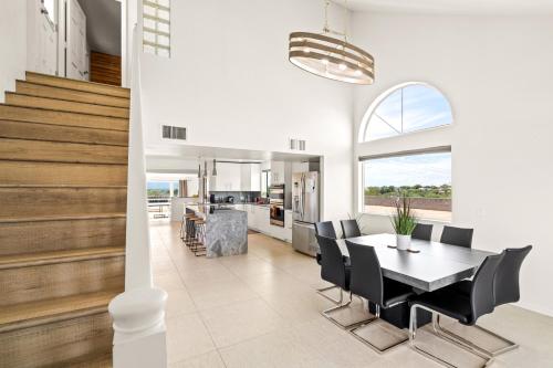 a dining room and kitchen with a table and chairs at Hill Top - Scenic Villa W Panoramic Views & Pool in Tucson