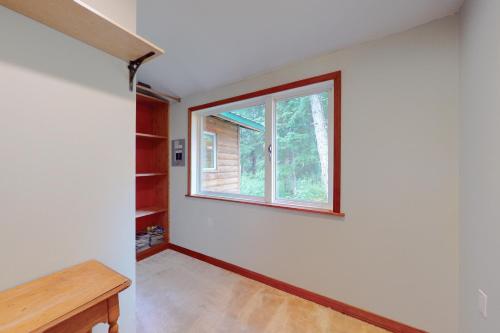 a room with a window and a wooden table at Alpina Cabin in Girdwood