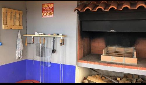 a kitchen with a pizza oven in a restaurant at Casa AIDA SEA VIEW in Relógio do Poiso