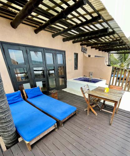 a patio with a bed and a table and a tub at Johnnys Place Hotel in Monterrico