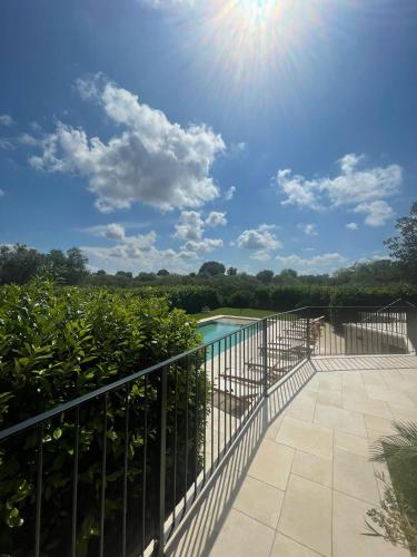 a balcony with a view of a swimming pool at Dimorae Camà in Cisternino