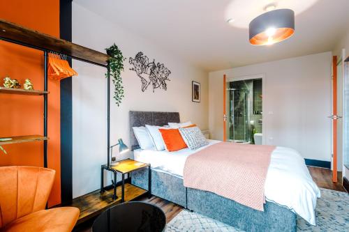 a bedroom with a bed with white sheets and orange pillows at Exceptional Rated Apartment Sheffield in Sheffield