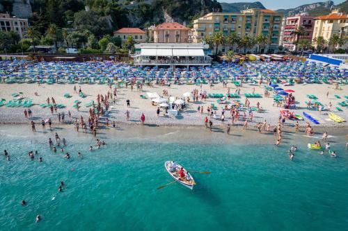a group of people on a beach in the water at Hotel Boncardo in Finale Ligure