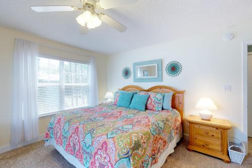 a bedroom with a bed and a window at Footprints In The Sand in St. George Island