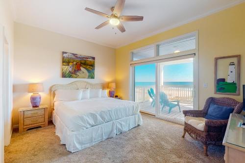 a bedroom with a bed and a view of the ocean at See Escape in St. George Island