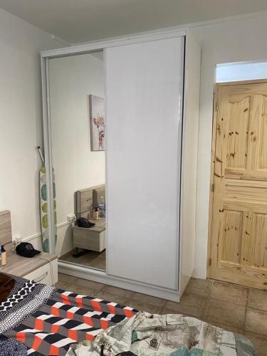 a bedroom with a sliding glass door and a bed at La Maison ka in Bouillante