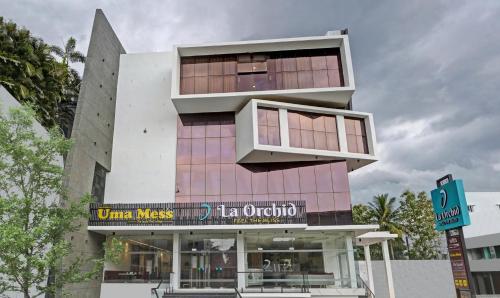 a building with a sign that reads united masses in ontario at Treebo Premium La Orchid, Big Temple in Thanjāvūr