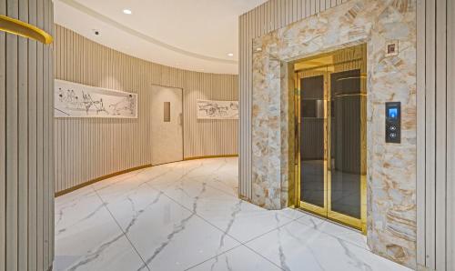 a lobby with a marble floor and a elevator at Treebo Premium La Orchid, Big Temple in Thanjāvūr