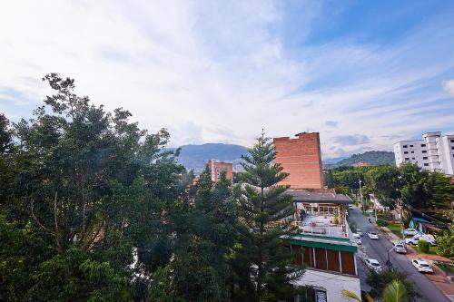 a view of a city with trees and buildings at Hotel Pass, Laureles Medellín in Medellín