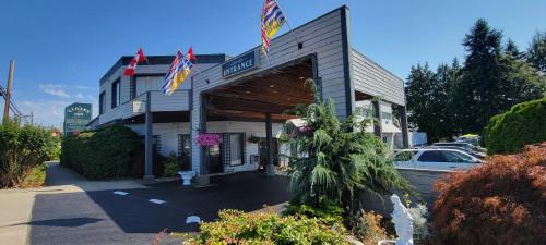 a restaurant with flags in front of a building at The Cedars Inn Hotel & Convention Centre in Gibsons