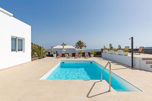a swimming pool on the side of a house at Sea Sky Lanzarote in Playa Blanca