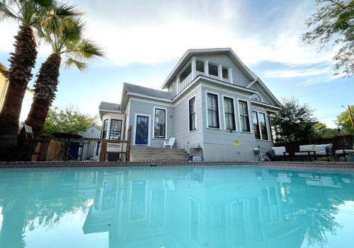 a house with a swimming pool in front of a house at Sparkling pool home 6-BR Oasis Near Downtown in San Antonio