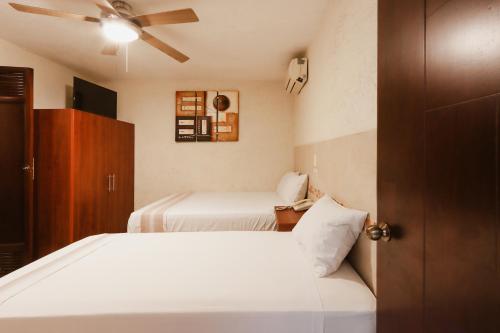 Postel nebo postele na pokoji v ubytování Hotel Guivá Huatulco