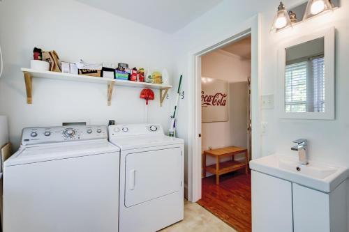 a laundry room with a washer and dryer and a sink at Sullivan's Island Serenity in Sullivans Island