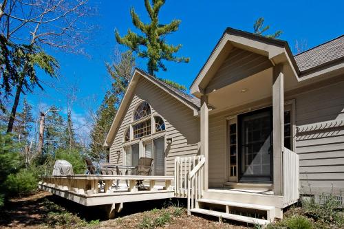 a house with a porch with chairs on it at Creeping Snails in Glen Arbor