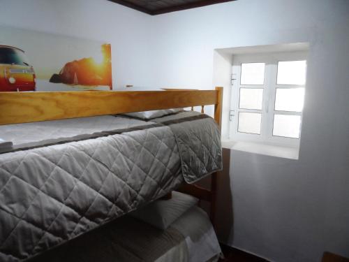 a bedroom with a bed and a window at Villa Santos in São Gregório