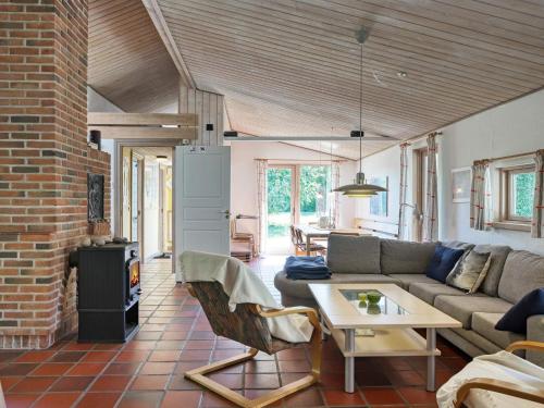 a living room with a couch and a table at 10 person holiday home in Dannemare-By Traum in Dannemare