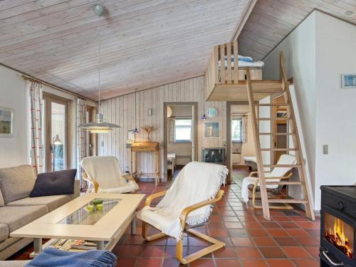 a living room with a loft bed and a ladder at 10 person holiday home in Dannemare-By Traum in Dannemare