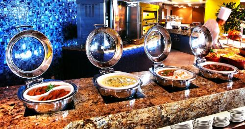a group of bowls of food on a counter at SkyCity Hotel Auckland in Auckland