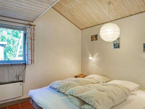 a bedroom with two beds and a window at 10 person holiday home in Dannemare-By Traum in Dannemare