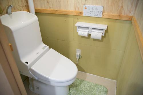 a bathroom with a toilet and two rolls of toilet paper at Guest House Waya in Sapporo
