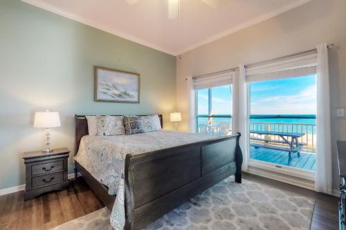 a bedroom with a bed with a view of the ocean at Sandstone in St. George Island
