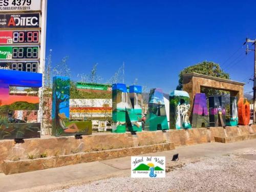 a wall with a bunch of art on it at Hotel Del Valle in El Naranjo