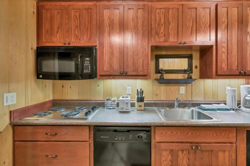 a kitchen with wooden cabinets and a sink and a stove at Seventh Mountain 1031 condo in Bend